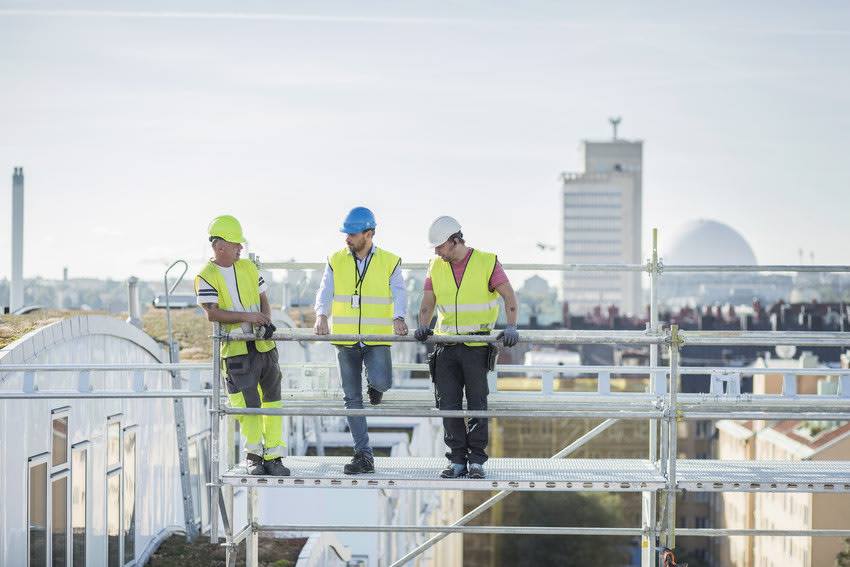 builders standing on Scaffolding